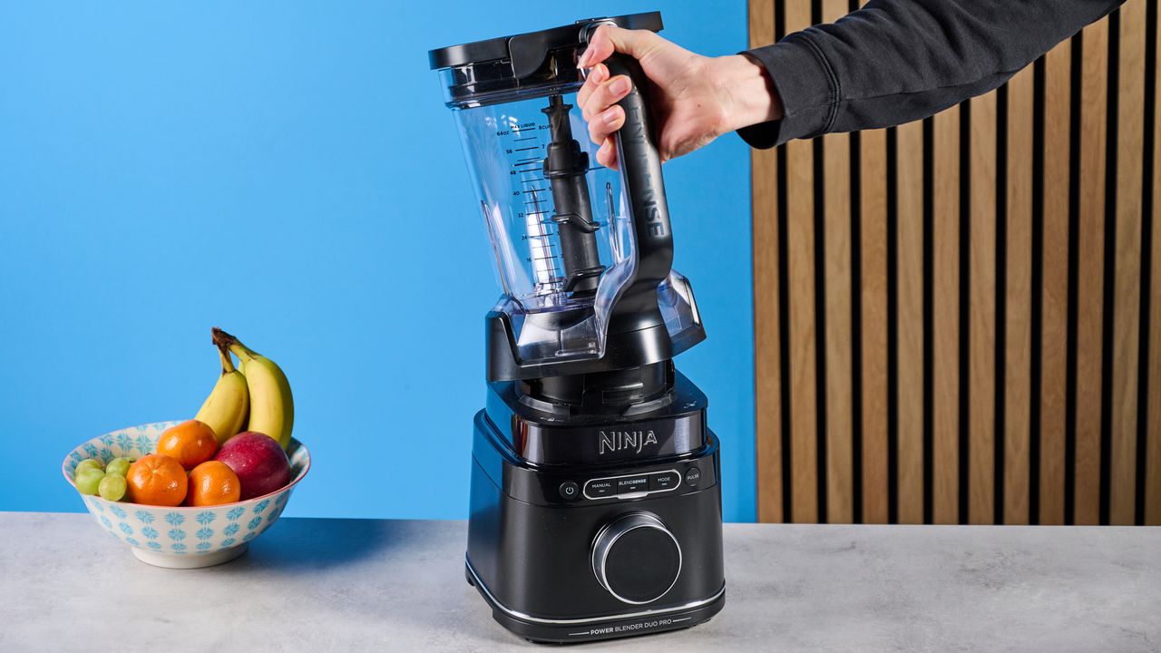 the ninja detect power pro with blendsense, a powerful blender with removable blades, a personal blender attachment, and control dial photographed against a blue background