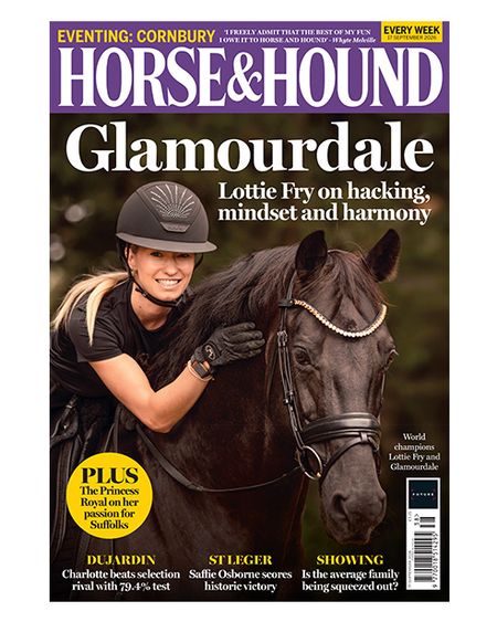 Lottie Fry reaches forward out of the saddle with her hand alongside Glamourdale's neck on the cover of Horse & Hound magazine. Glamourdale is wearing a snaffle bridle with a brass clencher browband.
