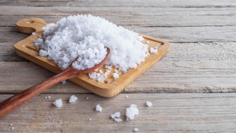 salt on a chopping board on a kitchen counter