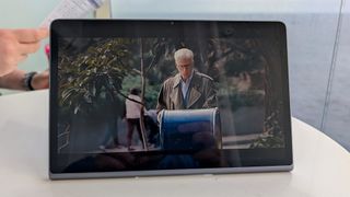 Lenovo Tab Plus sitting on a white table on a cruise showing a Netflix show.