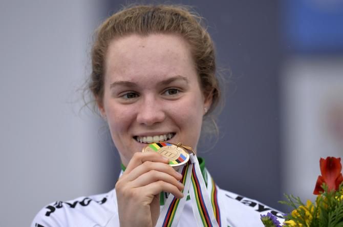 Anna-Leeze Hull (Australia) takes a bite out of her Bronze medal