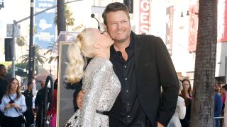 Gwen Stefani kissing Blake Shelton on the cheek at her Hollywood Walk of Fame Ceremony.