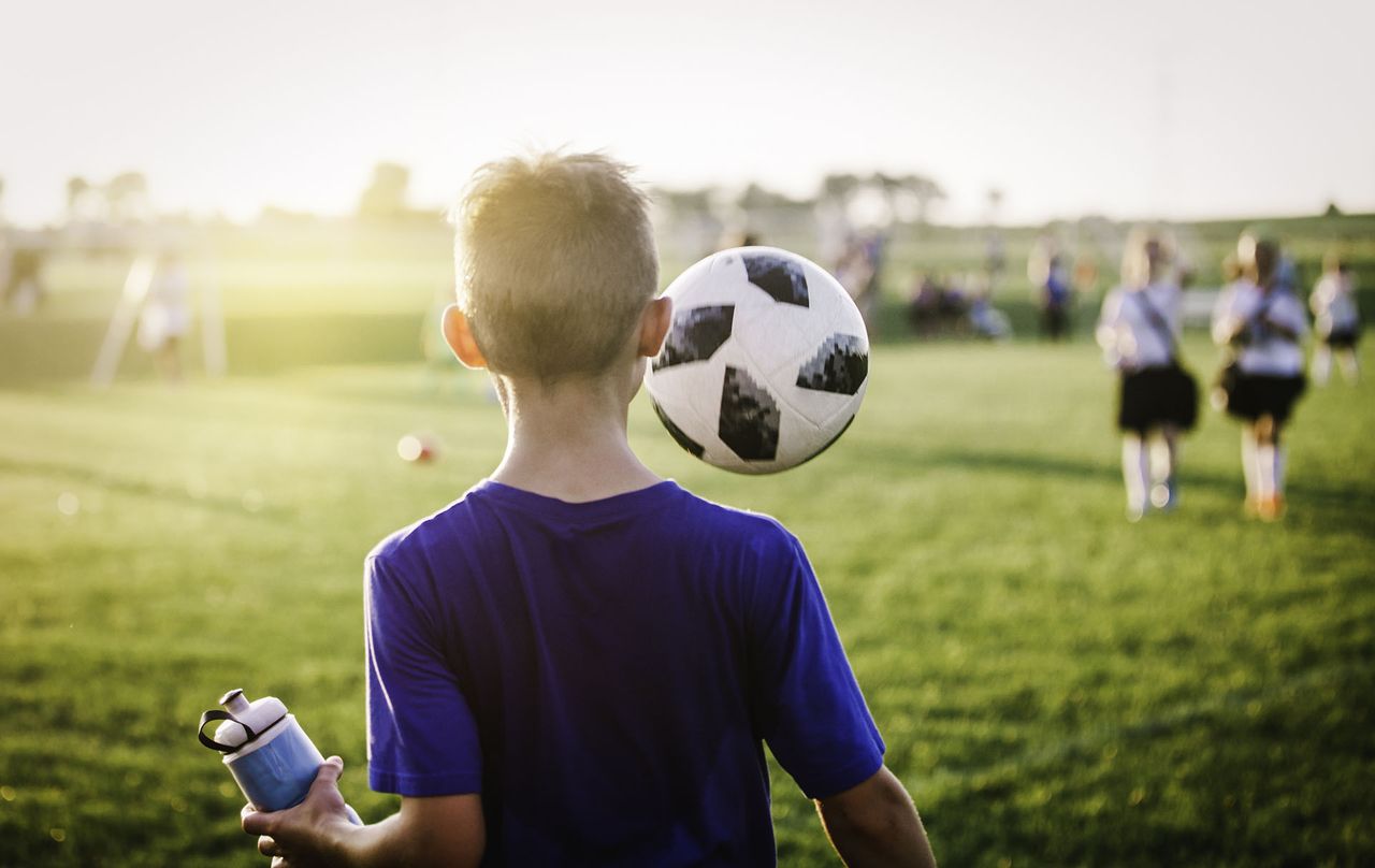 dad pushes son in football match