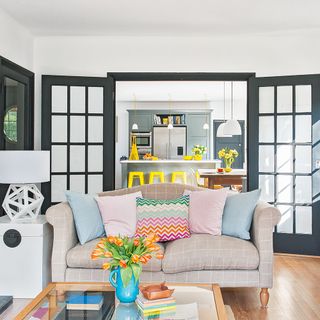 living room with black door and sofaset with cushions