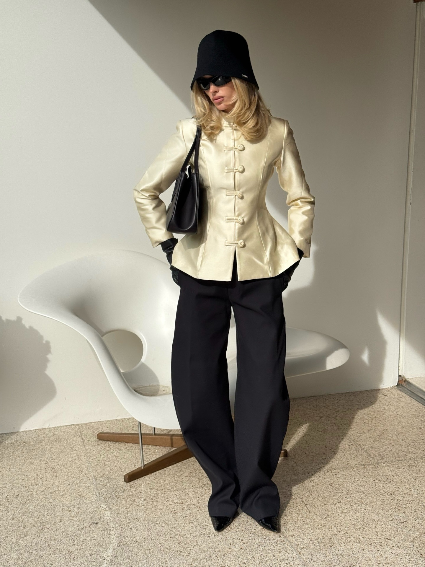 Elsa Hosk wearing a butter yellow jacket and black trousers