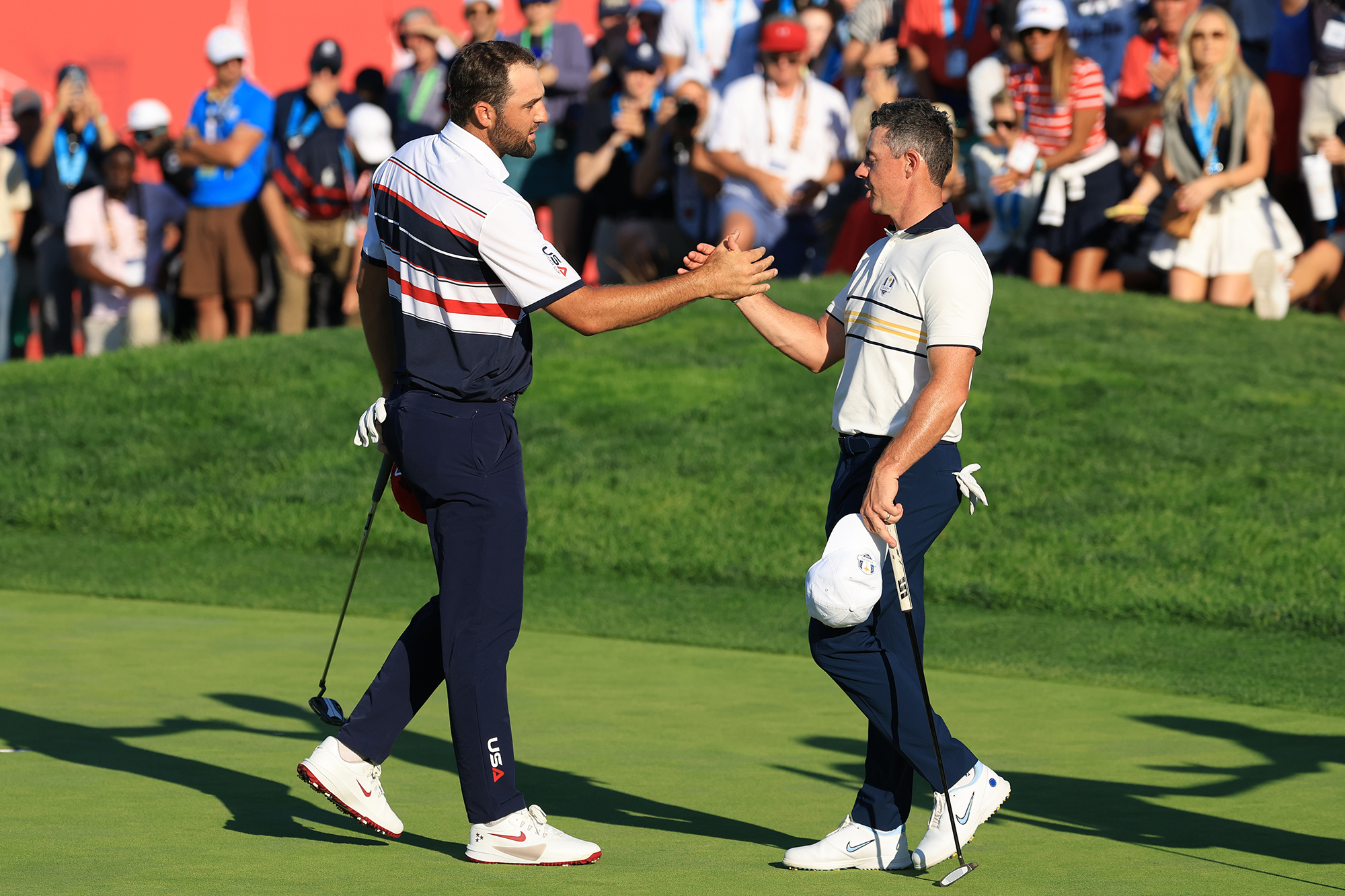Scottie Scheffler shaking hands with Rory McIlroy after defeating him in Sunday singles at the Ryder Cup in 2025