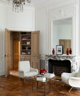 Living room in a Parisian apartment with an original marble fireplace