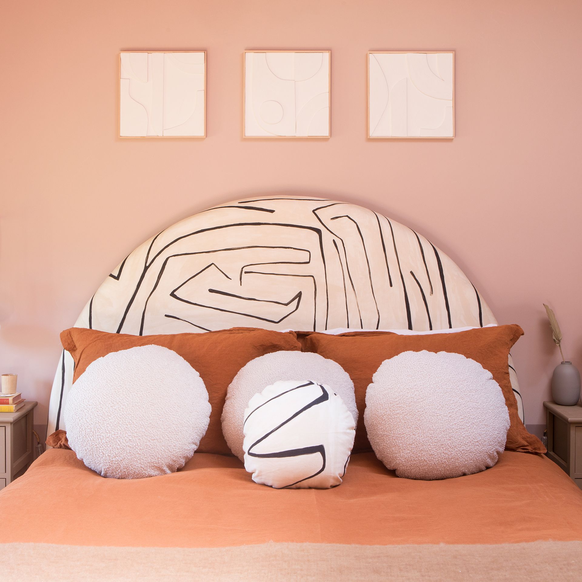 Peach walls with black and white headboard