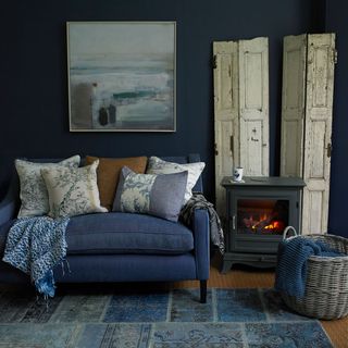 room with dark blue walls and fireplace