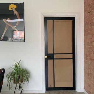 reeded glass door with cardboard panel