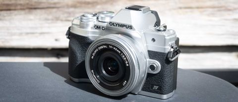 Olympus OM-D E-M10 Mark IV camera on a table outside