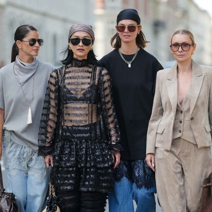 four women photographed walking on the street during Copenhagen Fashion Week