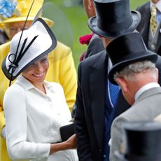 Meghan, Duchess of Sussex, laughs with King Charles at Day 1 of Royal Ascot in 2018