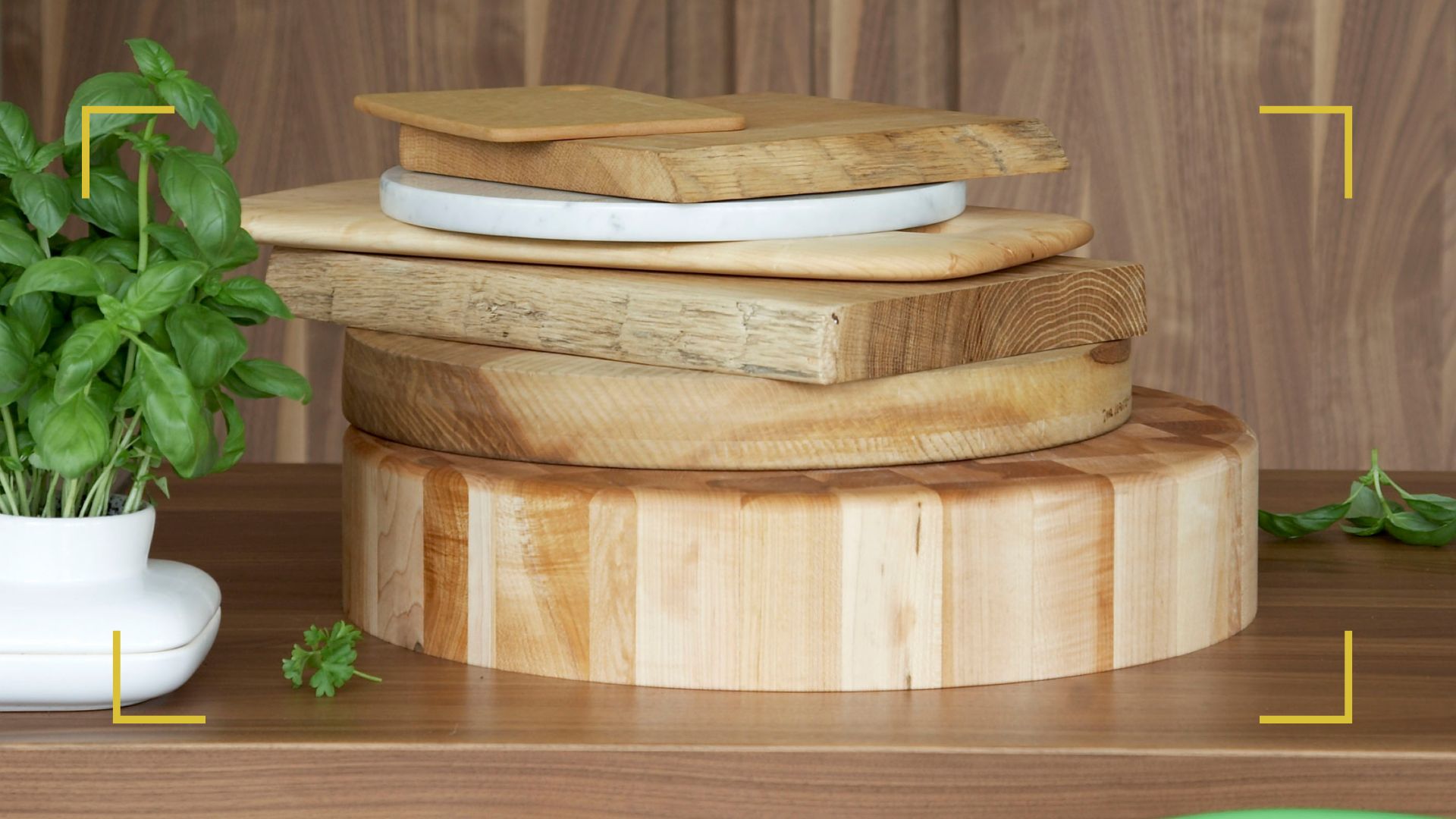 a stack of wooden chopping boards on a wooden countertop to support a guide on how to clean wooden chopping boards