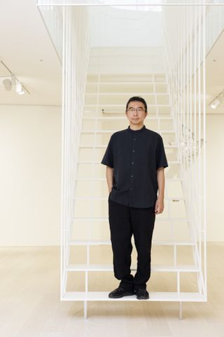 sou fujimoto shot on the staircase of pace tokyo, the japanese gallery he designed