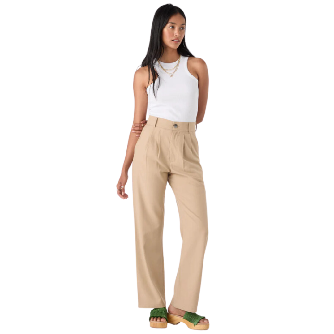 woman wearing beige trousers and white vest