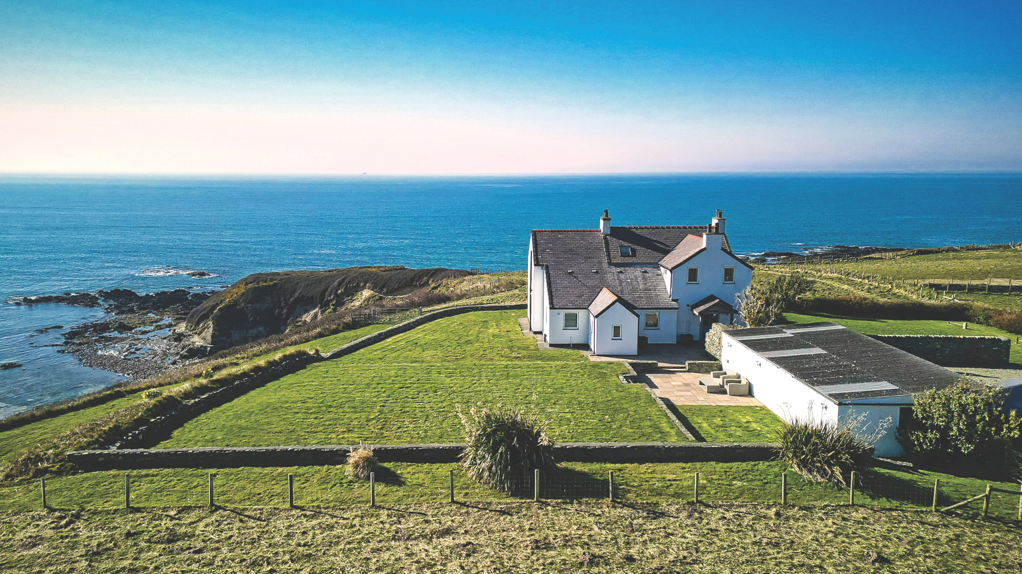 White house overlooking Trefadog Beach and Carmel Head.
