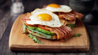 Two fried eggs on top of bacon and bread, one of the best foods for weight loss