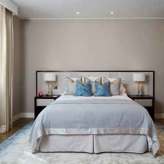 bedroom with blue cushion and white lamp