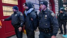 Police make an arrest as protesters hold a rally and march against ICE and the policies of the Donald Trump administration and its immigration policies in lower Manhattan on February 13, 2025 in New York City