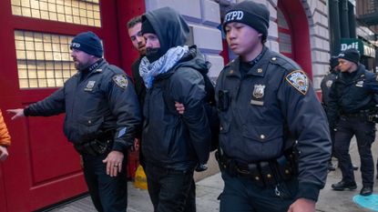 Police make an arrest as protesters hold a rally and march against ICE and the policies of the Donald Trump administration and its immigration policies in lower Manhattan on February 13, 2025 in New York City