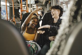 two women taking on a bus