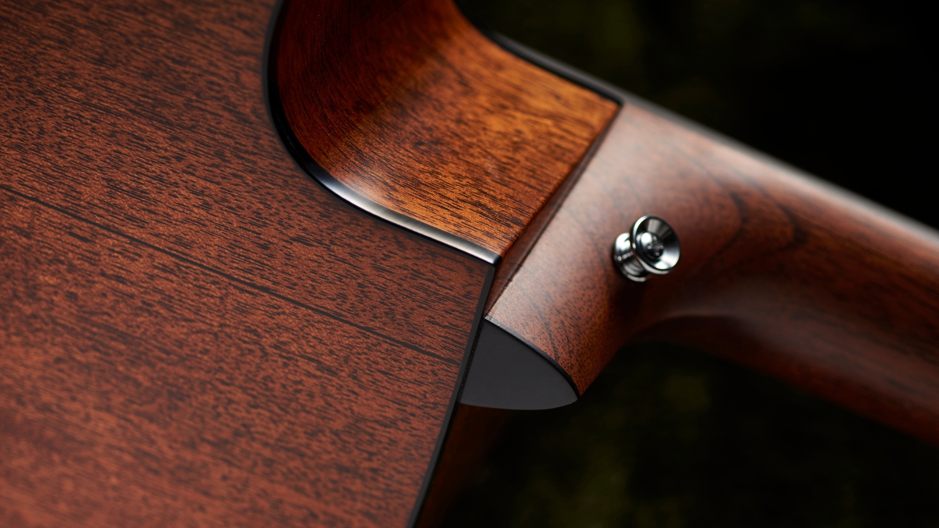 The neck strap pin on an acoustic guitar