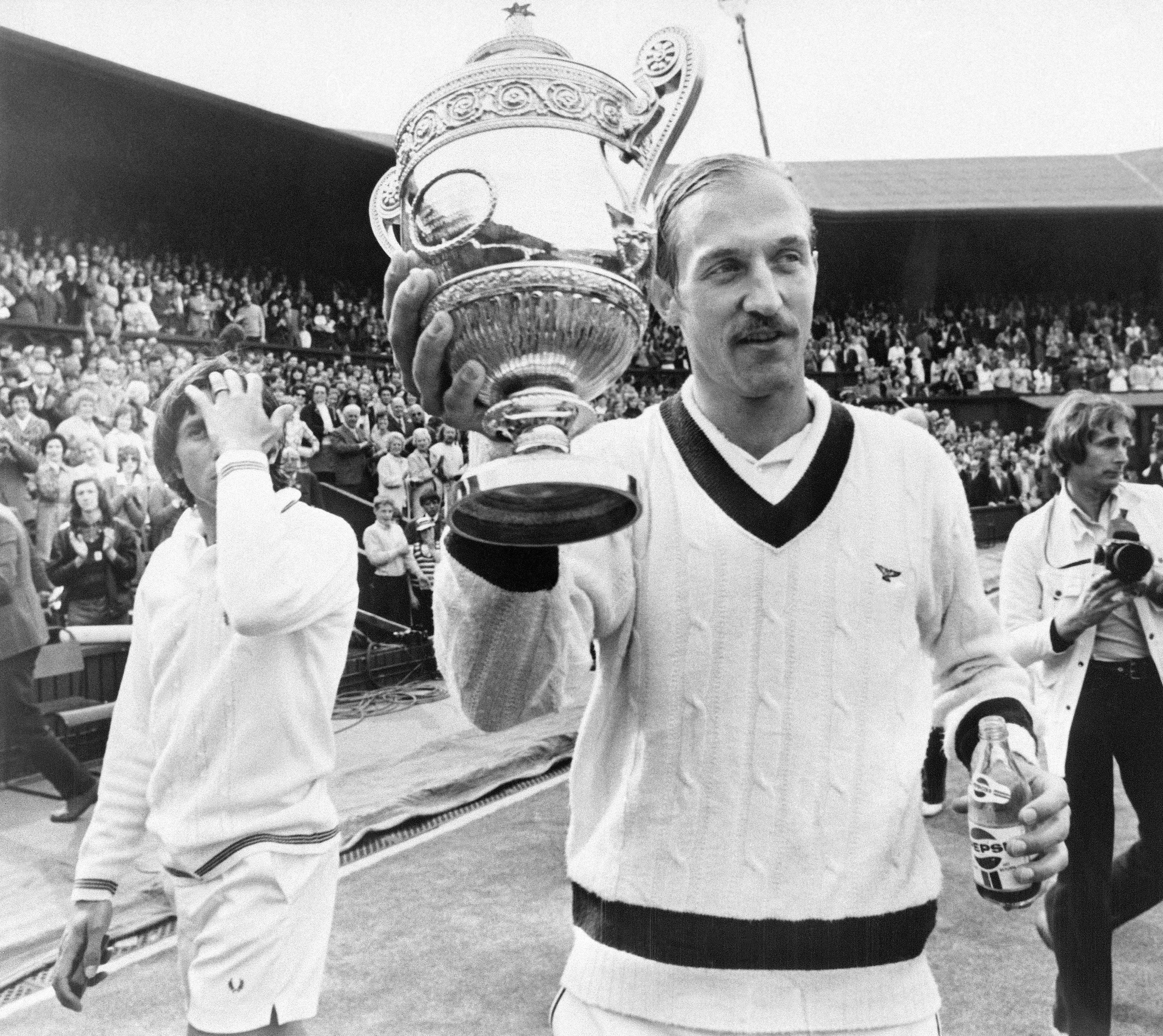 Stan Smith wins Wimbledon wearing a varsity sweater.