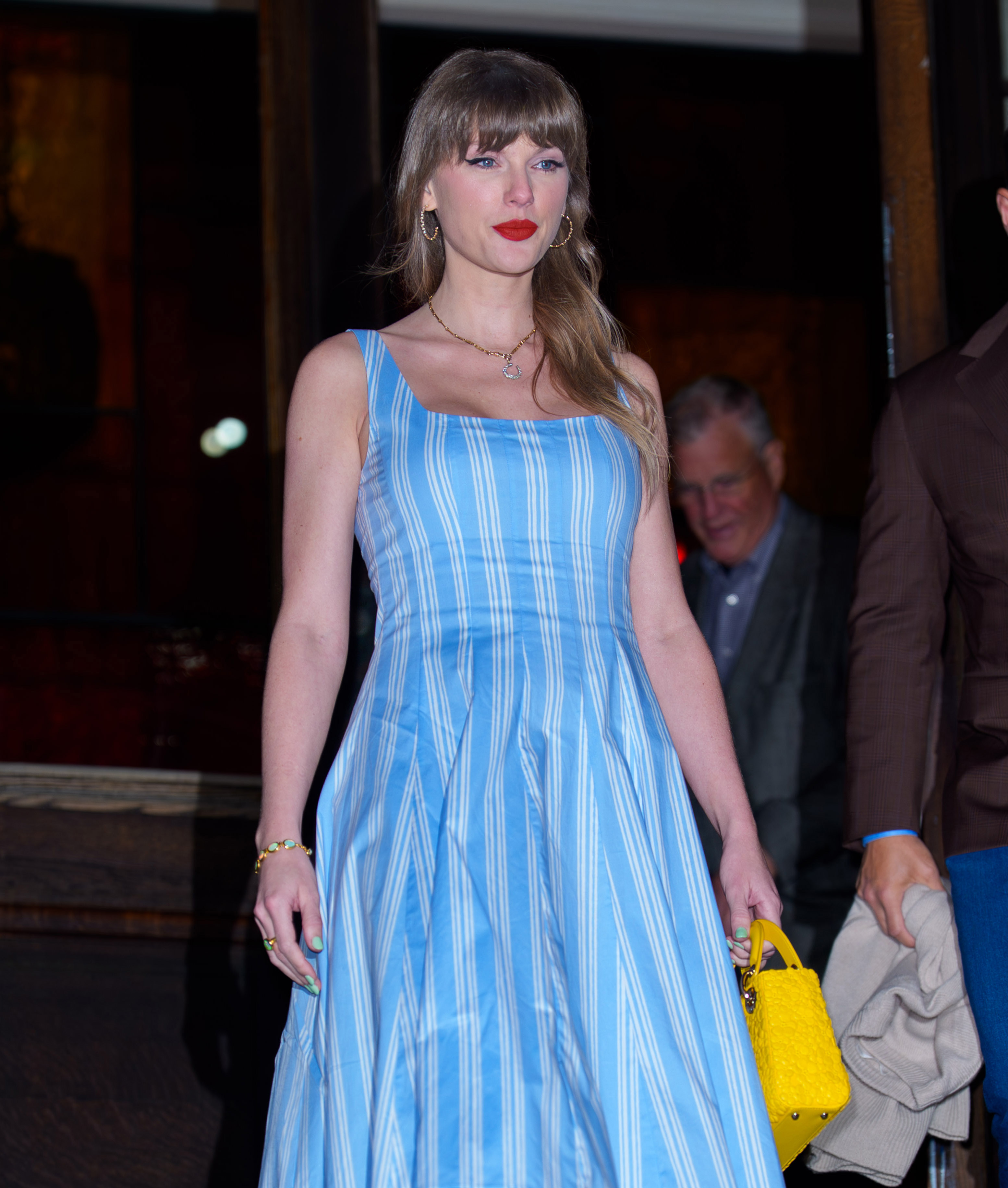 taylor swift wears a blue sundress with mint green nail polish