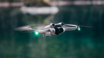 DJI Mini 3 Pro drone flying in a dramatic landscape