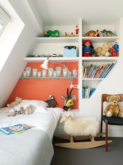 How to organize a kid&#039;s room with plenty of book storage and an orange wall