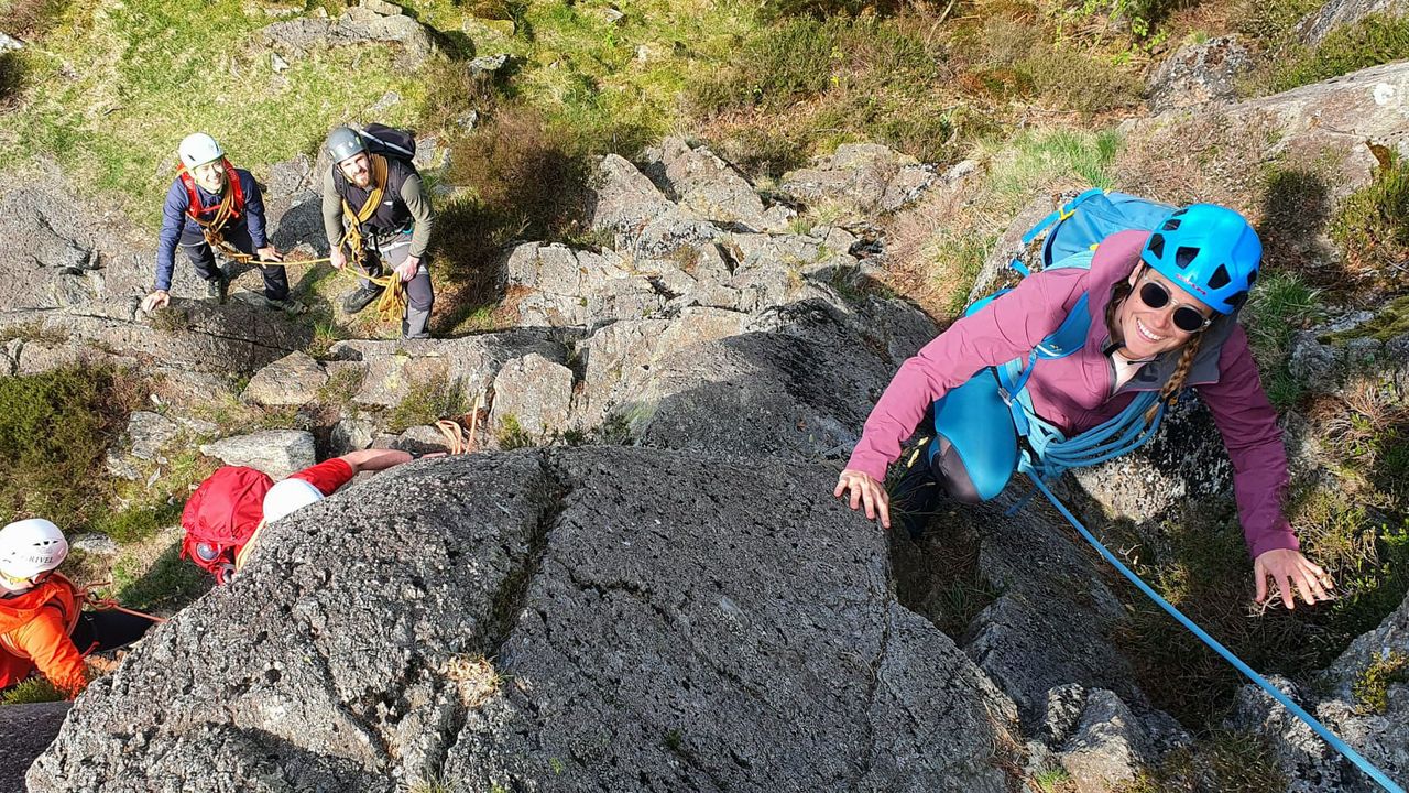 people doing roped scrambling