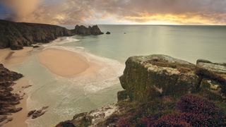 Campsites by the beach: view overlooking Porthcurno Bay from a coastal campsite