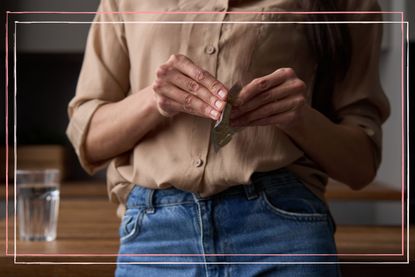 close up of women holding HRT pills