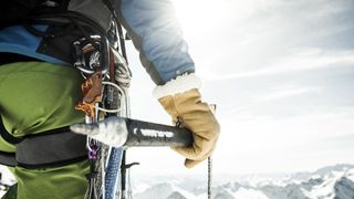 Close up of a mountaineer holding an ice axe