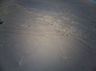 The targeted landing zone for Ingenuity’s 19th Mars flight can be seen in this image, which the helicopter captured during its ninth sortie on July 5, 2021. The targeted landing spot is in the center of the image, just below the Perseverance rover tracks.