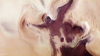 An angel-like province of red sediment has appeared near the south pole of Mars. What created it?