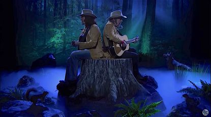 Two Neil Youngs on a tree stump, singing