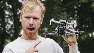 DJI Mini 5 Pro and DJI Mini 4K drones held by side by side