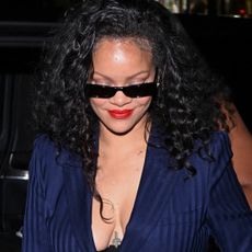 Rihanna wore the peekaboo bra trend with a pinstripe suit and a bedazzled Dior bag at C&eacute;line Dion's concert in Paris