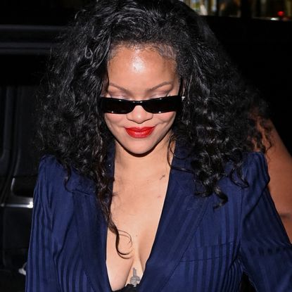 Rihanna wore the peekaboo bra trend with a pinstripe suit and a bedazzled Dior bag at C&eacute;line Dion's concert in Paris