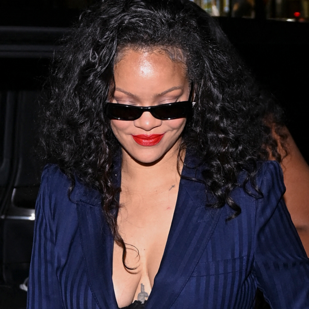 Rihanna wore the peekaboo bra trend with a pinstripe suit and a bedazzled Dior bag at C&eacute;line Dion's concert in Paris