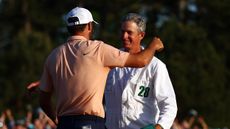 Scottie Scheffler and Ted Scott embrace after winning the 2024 Masters