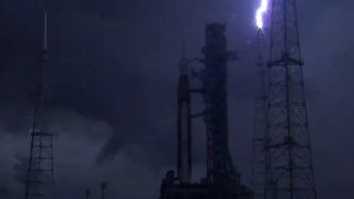 Lightning strikes one of the lightning towers at Pad 39B at Kennedy's Space Center in Florida on Aug. 27, 2022. NASA's Artemis 1 moon rocket is on the pad, awaiting a planned Aug. 29 launch.