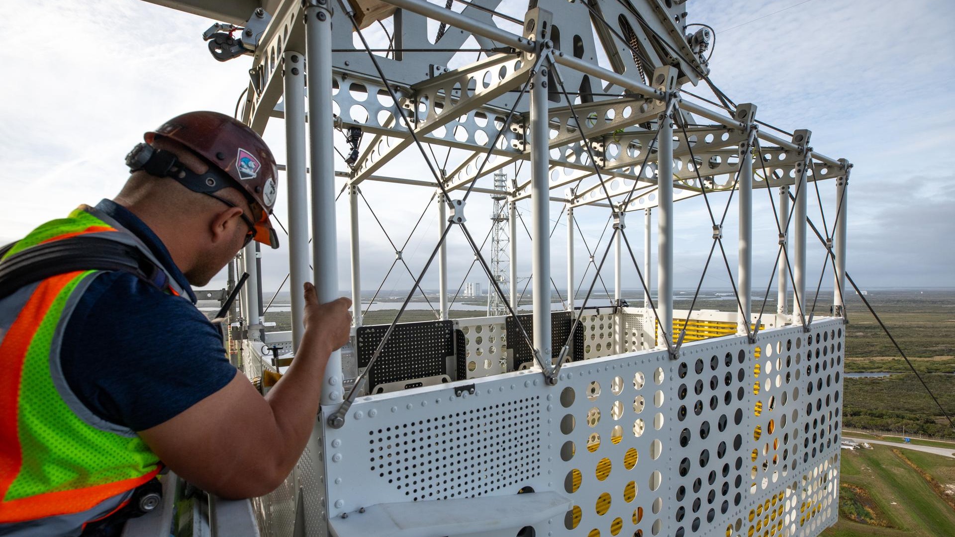 a basket for an escape system with a technician grasping the sides