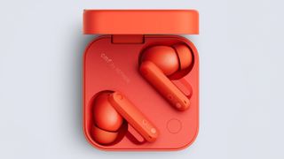 An orange pair of CMF by Nothing Buds Pro 2 wireless earbuds in their case