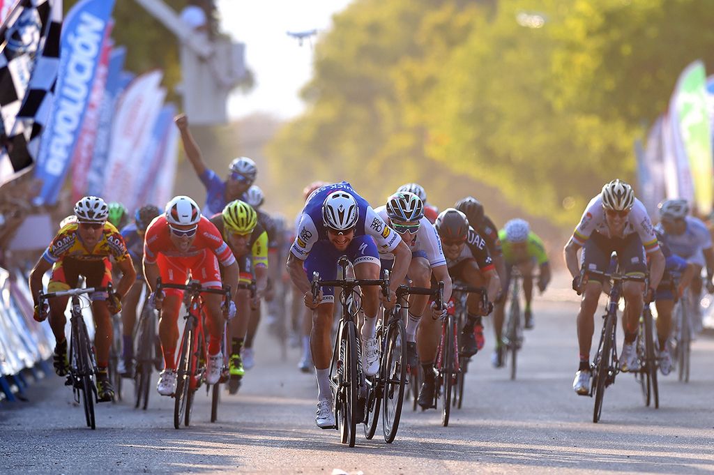 Fernando Gaviria punches the air in early celebration of Tom Boonen's (Quick-Step Floors) win