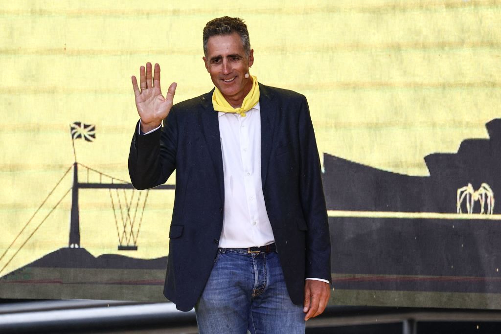 Former Spanish cyclist Miguel Indurain waves on stage during the official teams presentation near the Guggenheim Museum Bilbao in Bilbao northern Spain on June 29 2023 two days prior to the start of the 110th edition of the Tour de France cycling race Photo by AnneChristine POUJOULAT AFP Photo by ANNECHRISTINE POUJOULATAFP via Getty Images