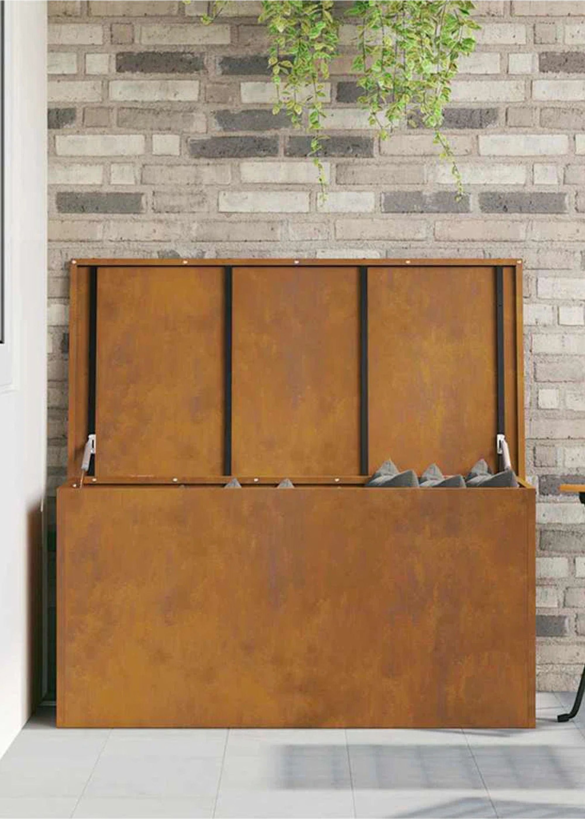 This Weathered Steel Chest Stores Outdoor Cushions in Style