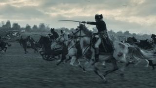 Napoleon (2023) riding into battle on horseback